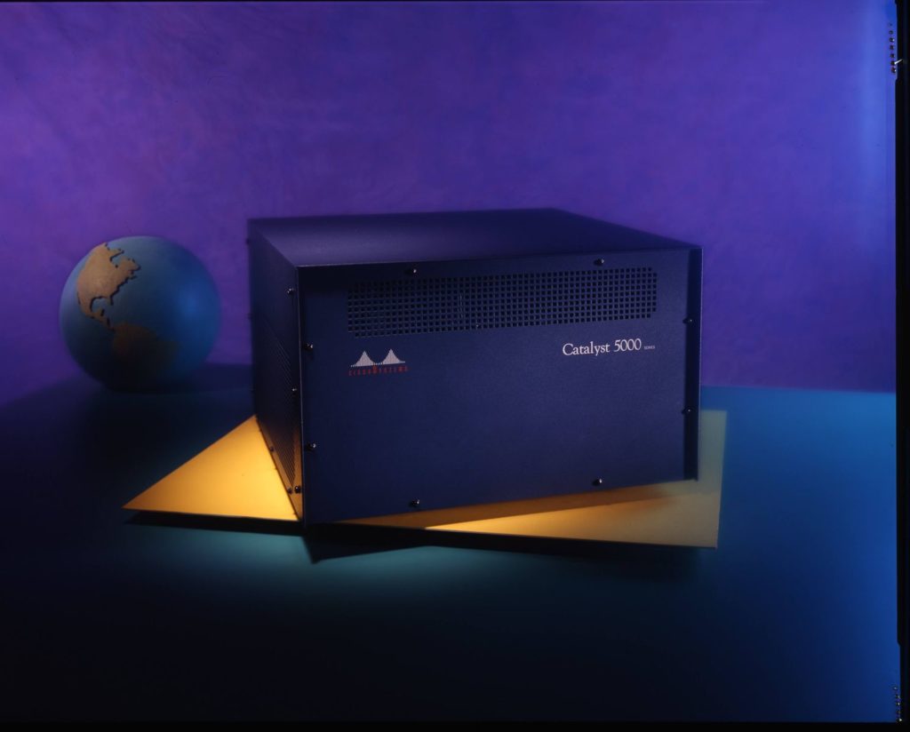 Catalyst 5000 chasis sitting on a purple and blue background with a globe