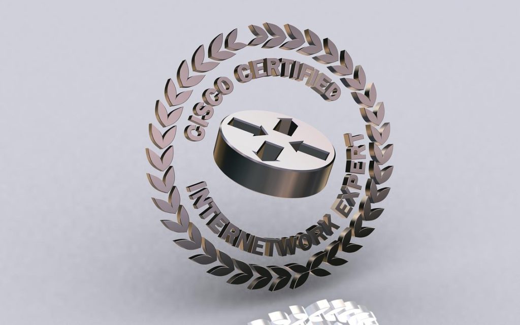 CCIE logo grey internetworking symbol in 3D surrounded by laurels